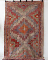 Vintage kilim rug in living room setting, old rug, antique rug, pastel colors, faded colors, Turkish rug, vintage rug, soft rug, Portland, Oregon, rug store, rug shop, local shop, earthy tones, earthy colors, warm colors
