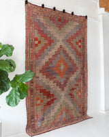 Vintage kilim rug in living room setting, old rug, antique rug, pastel colors, faded colors, Turkish rug, vintage rug, soft rug, Portland, Oregon, rug store, rug shop, local shop, earthy tones, earthy colors, warm colors
