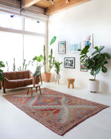Vintage kilim rug in living room setting, old rug, antique rug, pastel colors, faded colors, Turkish rug, vintage rug, soft rug, Portland, Oregon, rug store, rug shop, local shop, earthy tones, earthy colors, warm colors