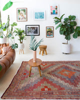 Vintage kilim rug in living room setting, old rug, antique rug, pastel colors, faded colors, Turkish rug, vintage rug, soft rug, Portland, Oregon, rug store, rug shop, local shop, earthy tones, earthy colors, warm colors