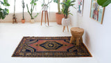 Vintage Turkish rug in a living room setting, pile rug, Turkish rug, vintage rug, portland, rug shop, bright colors, wild shaman, soft rug, bold color, Portland, Oregon, rug store, rug shop, local shop, antique rug