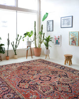 Antique Persian area rug in a living room setting, pile rug, Turkish rug, old rug, antique rug, pastel colors, faded colors, Turkish rug, vintage rug, soft rug, Portland, Oregon, rug store, rug shop, local shop, distressed rug, worn out rug