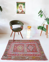Vintage kilim rug in room decor setting, old rug, antique rug, pastel colors, faded colors, Turkish rug, vintage rug, soft rug, Portland, Oregon, rug store, rug shop, local shop, distressed rug, worn out rug