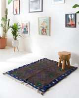 Vintage Turkish rug in a living room setting, pile rug, Turkish rug, vintage rug, portland, rug shop, bright colors, wild shaman, soft rug, bold color, Portland, Oregon, rug store, rug shop, local shop