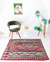 Vintage kilim rug in room decor setting, old rug, antique rug, pastel colors, faded colors, Turkish rug, vintage rug, soft rug, Portland, Oregon, rug store, rug shop, local shop, distressed rug, worn out rug