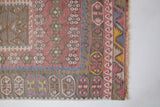 Vintage kilim rug in room decor setting, old rug, antique rug, pastel colors, faded colors, Turkish rug, vintage rug, soft rug, Portland, Oregon, rug store, rug shop, local shop, distressed rug, worn out rug