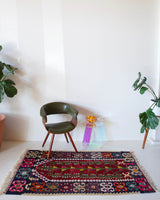 Vintage kilim rug in room decor setting, kilim, Turkish rug, vintage rug, portland, rug shop, bright colors, wild shaman, soft rug, bold color, Portland, Oregon, rug store, rug shop, local shop, antique rug