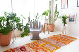 Vintage Turkish runner rug in a living room setting, pile rug, Turkish rug, vintage rug, portland, rug shop, bright colors, wild shaman, soft rug, bold color, Portland, Oregon, rug store, rug shop, local shop, antique rug