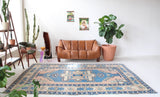 Vintage Turkish rug in living room setting, old rug, antique rug, pastel colors, faded colors, Turkish rug, vintage rug, soft rug, Portland, Oregon, rug store, rug shop, local shop