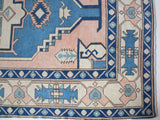 Vintage Turkish rug in living room setting, old rug, antique rug, pastel colors, faded colors, Turkish rug, vintage rug, soft rug, Portland, Oregon, rug store, rug shop, local shop
