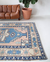 Vintage Turkish rug in living room setting, old rug, antique rug, pastel colors, faded colors, Turkish rug, vintage rug, soft rug, Portland, Oregon, rug store, rug shop, local shop