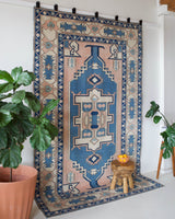 Vintage Turkish rug in living room setting, old rug, antique rug, pastel colors, faded colors, Turkish rug, vintage rug, soft rug, Portland, Oregon, rug store, rug shop, local shop