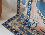 Vintage Turkish rug in living room setting, old rug, antique rug, pastel colors, faded colors, Turkish rug, vintage rug, soft rug, Portland, Oregon, rug store, rug shop, local shop
