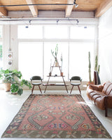 Vintage kilim rug in living room setting, old rug, antique rug, pastel colors, faded colors, Turkish rug, vintage rug, soft rug, Portland, Oregon, rug store, rug shop, local shop