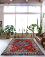Vintage Turkish rug in a living room setting, pile rug, Turkish rug, vintage rug, portland, rug shop, bright colors, wild shaman, soft rug, bold color, Portland, Oregon, rug store, rug shop, local shop, antique rug