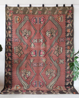 Vintage kilim rug in living room setting, old rug, antique rug, pastel colors, faded colors, Turkish rug, vintage rug, soft rug, Portland, Oregon, rug store, rug shop, local shop