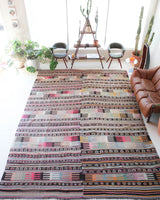 Vintage kilim rug in room decor setting, old rug, antique rug, pastel colors, faded colors, Turkish rug, vintage rug, soft rug, Portland, Oregon, rug store, rug shop, local shop, distressed rug, worn out rug