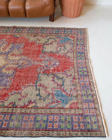 Vintage Turkish  rug in a living room setting, pile rug, Turkish rug, vintage rug, portland, rug shop, bright colors, wild shaman, soft rug, bold color, Portland, Oregon, rug store, rug shop, local shop, antique rug, distressed rug, worn out rug