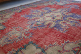 Vintage Turkish  rug in a living room setting, pile rug, Turkish rug, vintage rug, portland, rug shop, bright colors, wild shaman, soft rug, bold color, Portland, Oregon, rug store, rug shop, local shop, antique rug, distressed rug, worn out rug