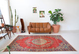 Vintage Turkish  rug in a living room setting, pile rug, Turkish rug, vintage rug, portland, rug shop, bright colors, wild shaman, soft rug, bold color, Portland, Oregon, rug store, rug shop, local shop, antique rug, distressed rug, worn out rug
