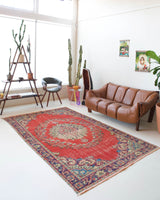 Vintage Turkish  rug in a living room setting, pile rug, Turkish rug, vintage rug, portland, rug shop, bright colors, wild shaman, soft rug, bold color, Portland, Oregon, rug store, rug shop, local shop, antique rug, distressed rug, worn out rug