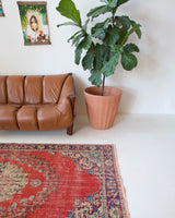 Vintage Turkish  rug in a living room setting, pile rug, Turkish rug, vintage rug, portland, rug shop, bright colors, wild shaman, soft rug, bold color, Portland, Oregon, rug store, rug shop, local shop, antique rug, distressed rug, worn out rug