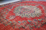 Vintage Turkish  rug in a living room setting, pile rug, Turkish rug, vintage rug, portland, rug shop, bright colors, wild shaman, soft rug, bold color, Portland, Oregon, rug store, rug shop, local shop, antique rug, distressed rug, worn out rug