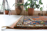 Vintage Turkish rug in a living room setting, pile rug, Turkish rug, vintage rug, portland, rug shop, bright colors, wild shaman, soft rug, bold color, Portland, Oregon, rug store, rug shop, local shop, antique rug