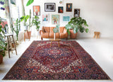 Antique Persian area rug in a living room setting, pile rug, vintage rug, portland, rug shop, bright colors, wild shaman, soft rug, bold color, Portland, Oregon, rug store, rug shop, local shop, antique rug, Persian rug, handmade rug, wool rug, distressed rug