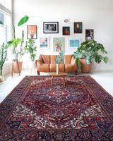 Antique Persian area rug in a living room setting, pile rug, vintage rug, portland, rug shop, bright colors, wild shaman, soft rug, bold color, Portland, Oregon, rug store, rug shop, local shop, antique rug, Persian rug, handmade rug, wool rug, distressed rug