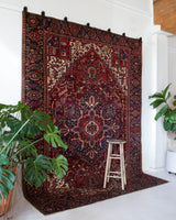 Antique Persian area rug in a living room setting, pile rug, vintage rug, portland, rug shop, bright colors, wild shaman, soft rug, bold color, Portland, Oregon, rug store, rug shop, local shop, antique rug, Persian rug, handmade rug, wool rug, distressed rug