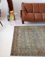 Vintage Turkish rug in living room setting, old rug, antique rug, pastel colors, faded colors, Turkish rug, vintage rug, soft rug, Portland, Oregon, rug store, rug shop, local shop