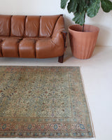Vintage Turkish rug in living room setting, old rug, antique rug, pastel colors, faded colors, Turkish rug, vintage rug, soft rug, Portland, Oregon, rug store, rug shop, local shop