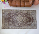 Vintage Turkish rug in living room setting, old rug, antique rug, pastel colors, faded colors, Turkish rug, vintage rug, distressed rug, worn out rug, Portland, Oregon, rug store, rug shop, local shop