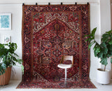 Antique Persian area rug in a living room setting, pile rug, vintage rug, portland, rug shop, bright colors, wild shaman, soft rug, bold color, Portland, Oregon, rug store, rug shop, local shop, antique rug, Persian rug, handmade rug, wool rug, distressed rug