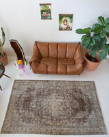 Vintage Turkish rug in living room setting, old rug, antique rug, pastel colors, faded colors, Turkish rug, vintage rug, distressed rug, worn out rug, Portland, Oregon, rug store, rug shop, local shop