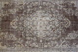 Vintage Turkish rug in living room setting, old rug, antique rug, pastel colors, faded colors, Turkish rug, vintage rug, distressed rug, worn out rug, Portland, Oregon, rug store, rug shop, local shop