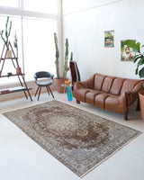 Vintage Turkish rug in living room setting, old rug, antique rug, pastel colors, faded colors, Turkish rug, vintage rug, distressed rug, worn out rug, Portland, Oregon, rug store, rug shop, local shop