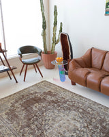 Vintage Turkish rug in living room setting, old rug, antique rug, pastel colors, faded colors, Turkish rug, vintage rug, distressed rug, worn out rug, Portland, Oregon, rug store, rug shop, local shop