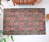 Vintage kilim rug in room decor setting, old rug, antique rug, pastel colors, faded colors, Turkish rug, vintage rug, soft rug, Portland, Oregon, rug store, rug shop, local shop, distressed rug, worn out rug
