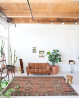 Vintage kilim rug in room decor setting, old rug, antique rug, pastel colors, faded colors, Turkish rug, vintage rug, soft rug, Portland, Oregon, rug store, rug shop, local shop, distressed rug, worn out rug