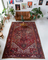 Antique Persian area rug in a living room setting, pile rug, vintage rug, portland, rug shop, bright colors, wild shaman, soft rug, bold color, Portland, Oregon, rug store, rug shop, local shop, antique rug, Persian rug, handmade rug, wool rug, distressed rug