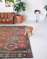 Vintage kilim rug in room decor setting, old rug, antique rug, pastel colors, faded colors, Turkish rug, vintage rug, soft rug, Portland, Oregon, rug store, rug shop, local shop, distressed rug, worn out rug
