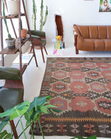 Vintage kilim rug in room decor setting, old rug, antique rug, pastel colors, faded colors, Turkish rug, vintage rug, soft rug, Portland, Oregon, rug store, rug shop, local shop, distressed rug, worn out rug
