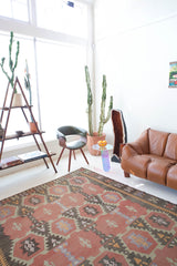 Vintage kilim rug in room decor setting, old rug, antique rug, pastel colors, faded colors, Turkish rug, vintage rug, soft rug, Portland, Oregon, rug store, rug shop, local shop, distressed rug, worn out rug