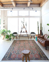 Vintage kilim rug in room decor setting, old rug, antique rug, pastel colors, faded colors, Turkish rug, vintage rug, soft rug, Portland, Oregon, rug store, rug shop, local shop, distressed rug, worn out rug