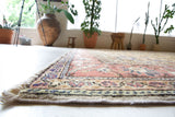 Area rug in a living room setting, pile rug, Turkish rug, old rug, antique rug, pastel colors, faded colors, Turkish rug, vintage rug, soft rug, Portland, Oregon, rug store, rug shop, local shop