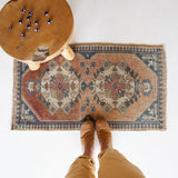 Vintage Turkish mini rug in room decor setting, old rug, antique rug, pastel colors, faded colors, Turkish rug, vintage rug, soft rug, Portland, Oregon, rug store, rug shop, local shop