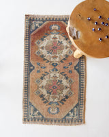 Vintage Turkish mini rug in room decor setting, old rug, antique rug, pastel colors, faded colors, Turkish rug, vintage rug, soft rug, Portland, Oregon, rug store, rug shop, local shop