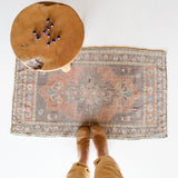 Vintage Turkish mini rug in room decor setting, old rug, antique rug, pastel colors, faded colors, Turkish rug, vintage rug, soft rug, Portland, Oregon, rug store, rug shop, local shop